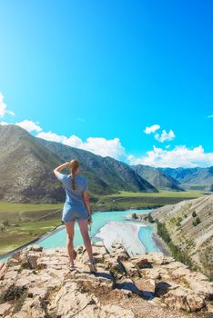 Woman taking selfie on mobile phone with stick. Vacation in the mountain