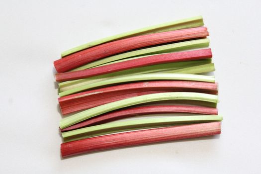 The picture shows colorful delicious rhubarb on a white background.