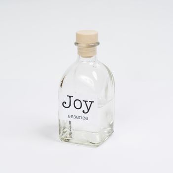 a glass bottle containing Joy essence