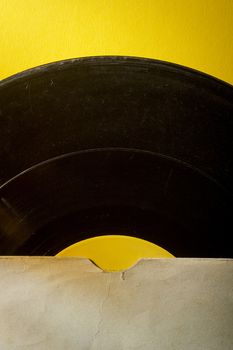 Vinyl record in an envelope on a yellow background