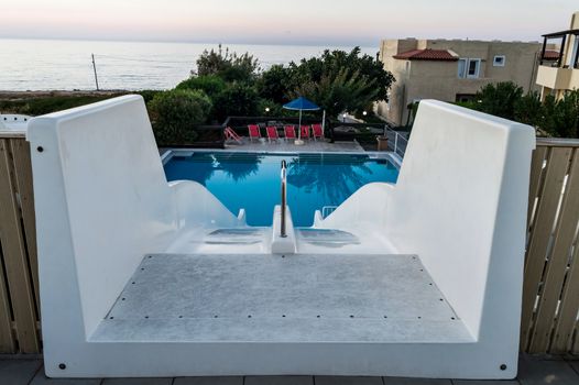 Double white water slide seen from the top of the pool in Crete