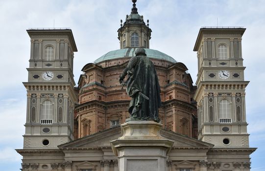 Photo of the Sanctuary of Mondovi with a monument in front of.