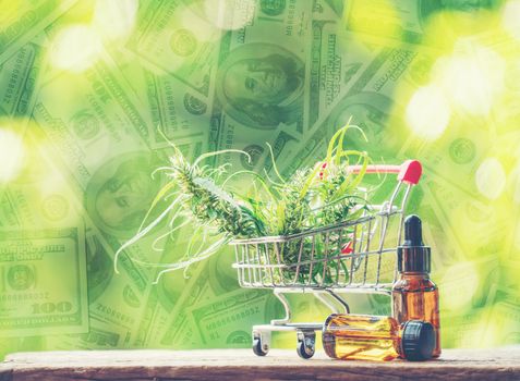 cannabidiol (cbd) extract in a shopping cart and dollar banknote background