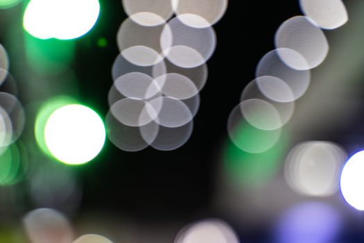 The colorful bokeh lights from vehicles on the road with traffic in dark night , in vintage film color style