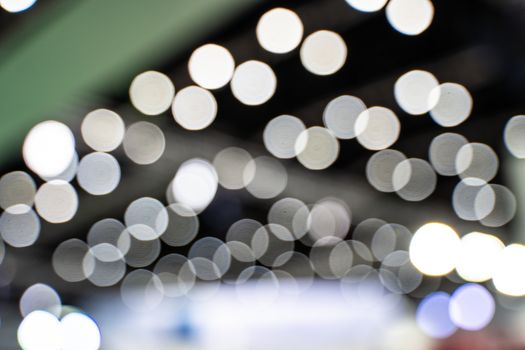 The colorful bokeh lights from vehicles on the road with traffic in dark night , in vintage film color style