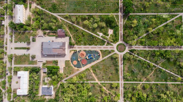 Children playground on yard activities in public park. Russia 2019. Children run, slide, swing, seesaw on modern playground. Urban neighborhood childhood concept.