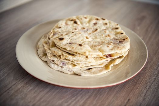 Greek pita bread on the plate.