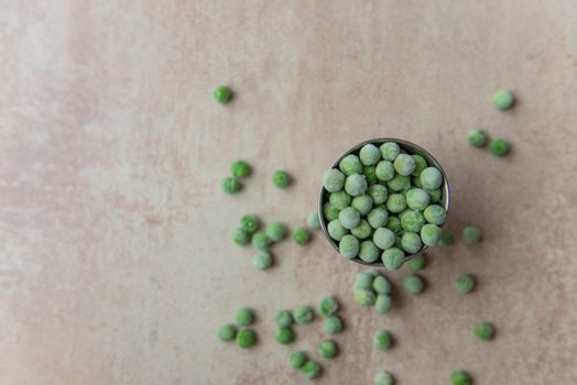 Small bucket with frozen peas.