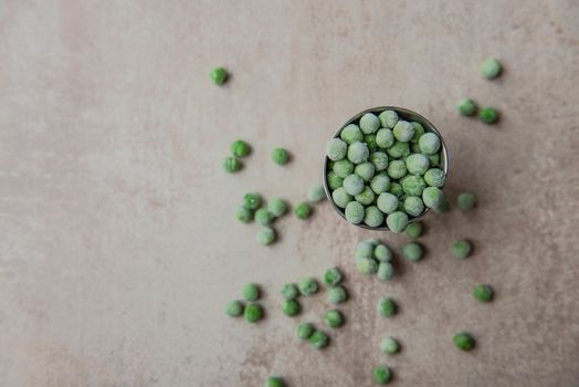 Small bucket with frozen peas.