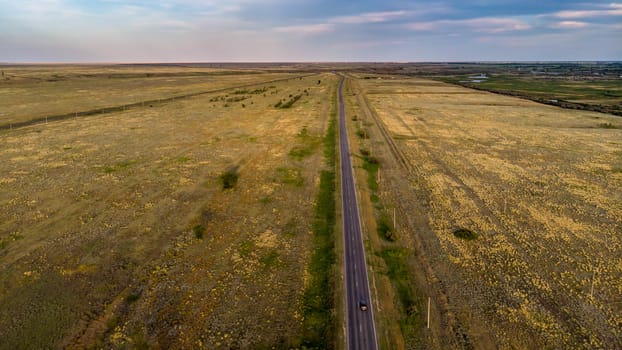 Empty asphalt road goes into the distance.