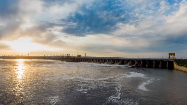 Powerful stream of water falls from the shutter in the dam, hydroelectric power plant