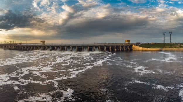 Powerful stream of water falls from the shutter in the dam, hydroelectric power plant