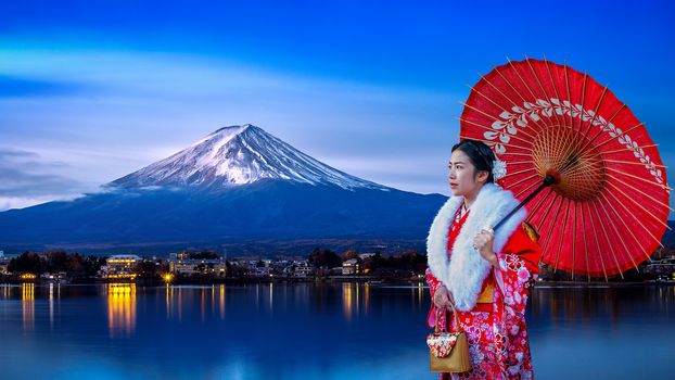 Asian woman wearing japanese traditional kimono at Fuji mountain, Kawaguchiko lake in Japan.