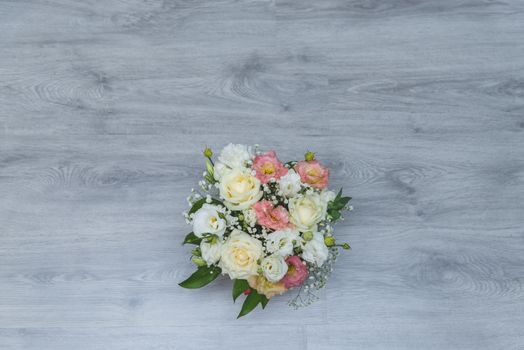 Garden flowers over grey wooden table background. Backdrop with copy space.