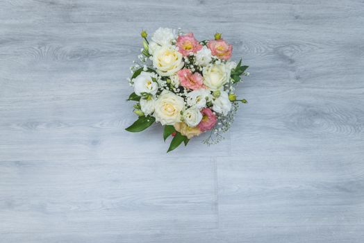 Garden flowers over grey wooden table background. Backdrop with copy space.