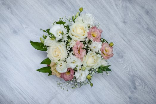 Garden flowers over grey wooden table background. Backdrop with copy space.