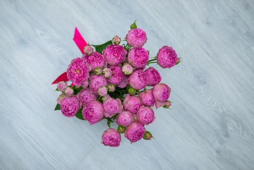 Garden flowers over grey wooden table background. Backdrop with copy space.