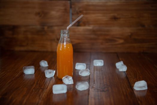 Ice fresh juice with ice cubes on table.