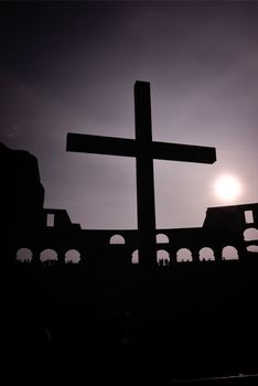 silhouette of the catalytic cross in the Coliseum. Italy