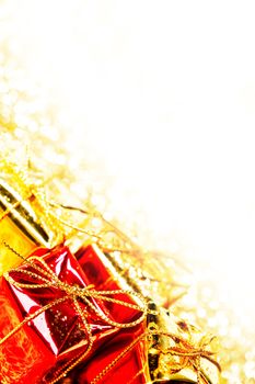 Decorative red and gold boxes with holiday gifts on shiny glitter background