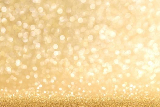 Golden festive glitter background with defocused lights