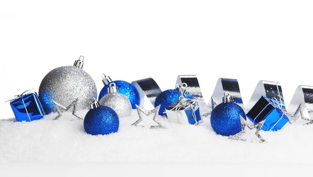 Christmas card with decorative baubles on snow