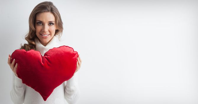 Beautiful woman with red pillow heart , valentine's day concept , white copy space for text
