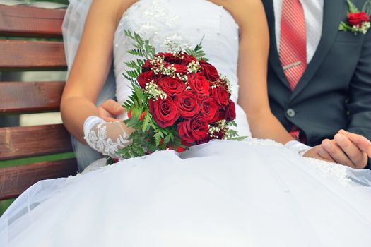 nice wedding bouquet in bride's hand. Kiss across bouquet