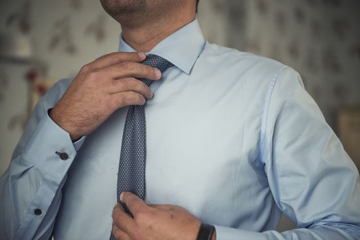 Businessman in suit and adjusting his necktie