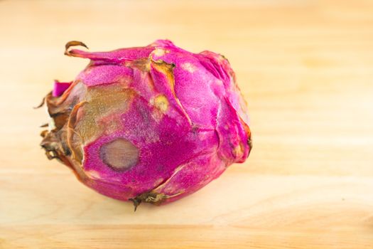 A Dragon fruit. The rare dragon fruit on a wooden background