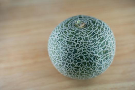 selected focus of A fresh green Melon on wooden background