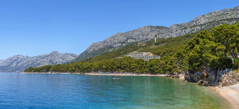 Panoramic view of the shore of the Adriatic Sea with mountains in the background in the district of Brela, Croatia