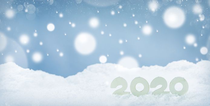 2020 New Year design concept. Wooden 2020 New Year horizontal template on snow on white bokeh backgound