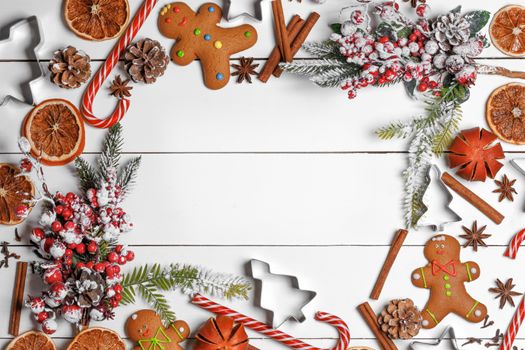 Christmas food frame. Gingerbread cookies, spices and decorations on white table background with copy space