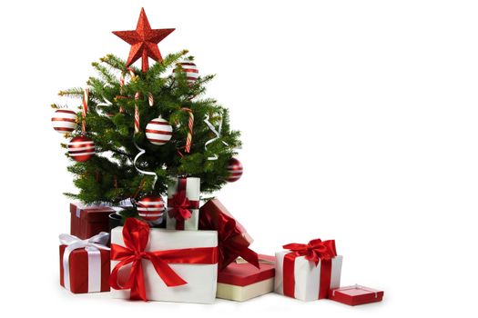 Decorated Christmas tree and gift boxes isolated on white background