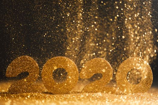 2020 New Year luxury design concept. Golden 2020 New Year horizontal template with golden glitter on black backgound