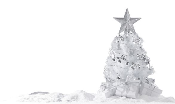White christmas tree with silver decorations and gifts on snow isolated on white background