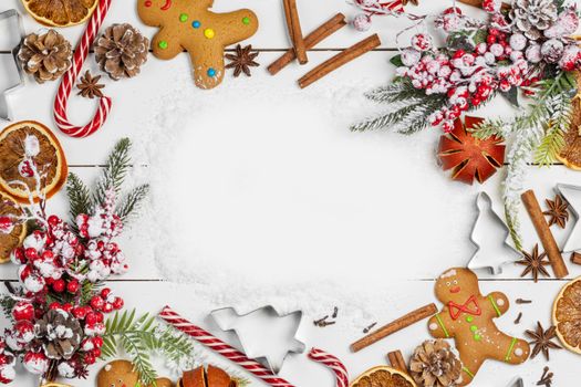 Christmas food frame. Gingerbread cookies, spices and decorations on white table background with copy space