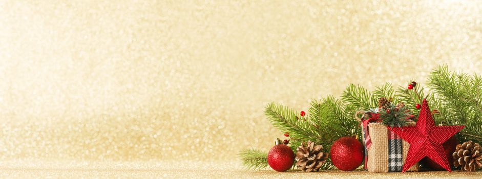 Christmas toys, decorations, present gift box wrapped in kraft paper on golden glitter background, copy space