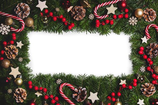 Christmas Border frame of tree branches on white background with copy space isolated, red and white decor, berries, stars, cones