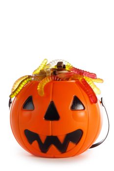 Halloween candies in Jack-O-Lantern bag isolated on white background