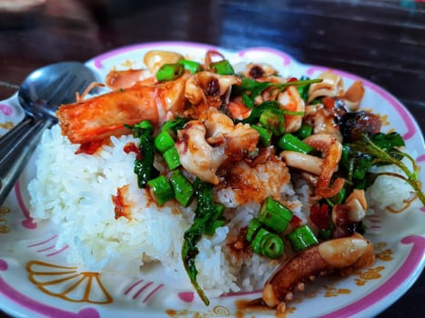 The Rice topped with stir-fried seafood and basil