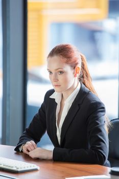 Pensive young businessman listening to explanations at seminar