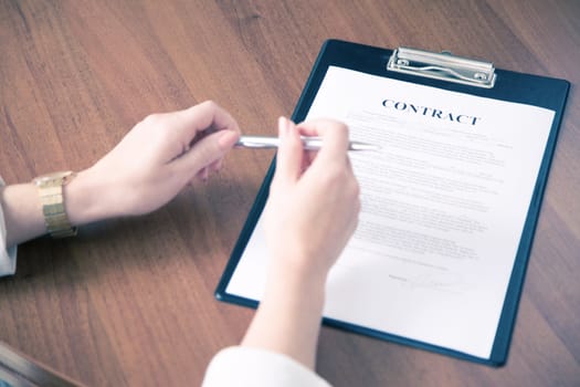 Close-up of business woman keeping hands on contract