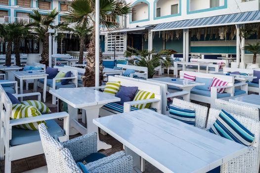 Great outdoor terrace of a restaurant with the colors of Greece in the city of Stalis in Crete