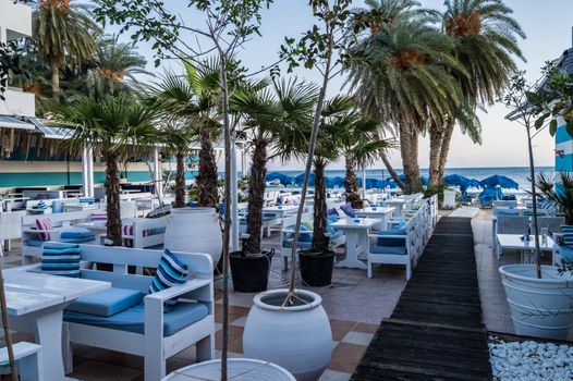 Great outdoor terrace of a restaurant with the colors of Greece in the city of Stalis in Crete