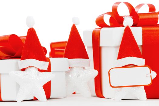 White gift boxes with red ribbons, stars with santa claus hats isolated on white background