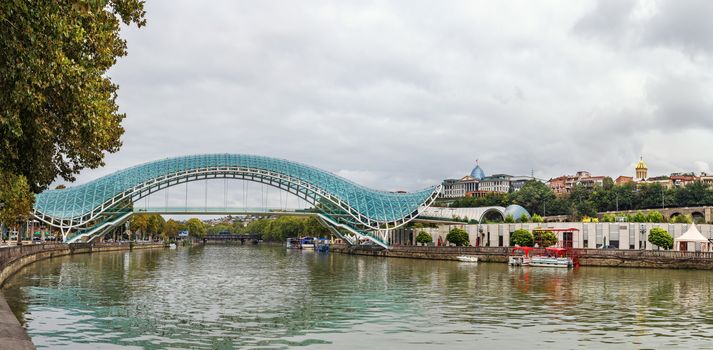 Panoramic view of Kura river with bridge of Peace in Tbilisi, Georgia