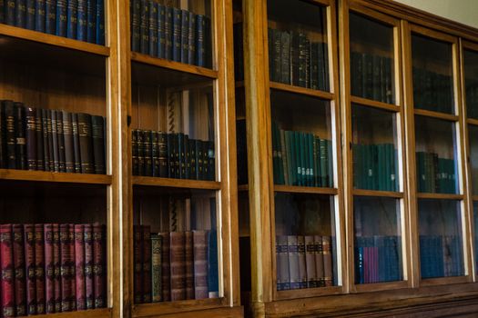 Old books in a wooden row library