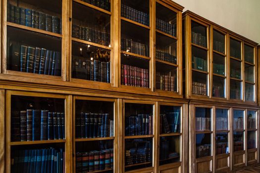 Old books in a wooden row library